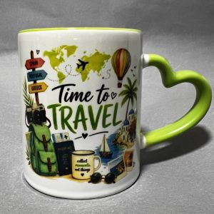 White mug decorated with travel-themed illustrations (world map, hot air balloon, signs to Spain and Portugal) and the words 'Time to Travel'; lime-green handle and rim introduce bright color.