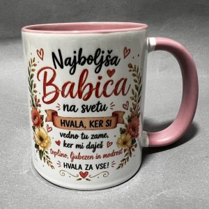 White ceramic mug with pink rim and handle, featuring red cursive text and hearts in Slovenian, surrounded by floral motifs and a banner reading 'Hvala za vse!'