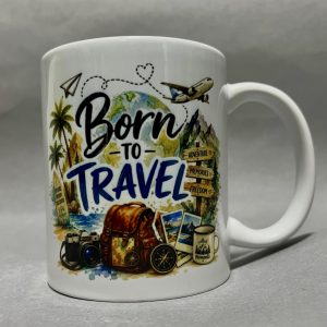 Mug with a travel-themed collage: globe, palm trees, luggage, camera, and the phrase “Born to Travel.”