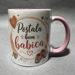Close-up of a white ceramic mug with a pink handle and Valentine’s themed design featuring red hearts and cursive text.