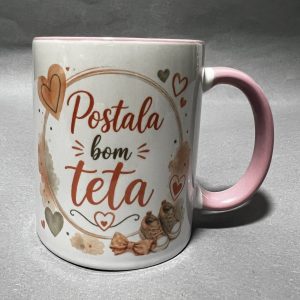 White mug with a pink handle, orange hearts, and red cursive text; coffee stains around the base on a gray surface.