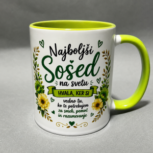 White ceramic mug with a lime-green interior/handle; features Slovenian text 'Najboljši Sosed na svetu' with a green floral border.