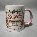 Close-up of a white ceramic mug with a pink handle, decorated with flowers and red hearts and Slovenian text.