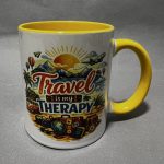 White ceramic mug with a bright yellow interior and handle, decorated with a travel landscape illustration and the word 'Travel'